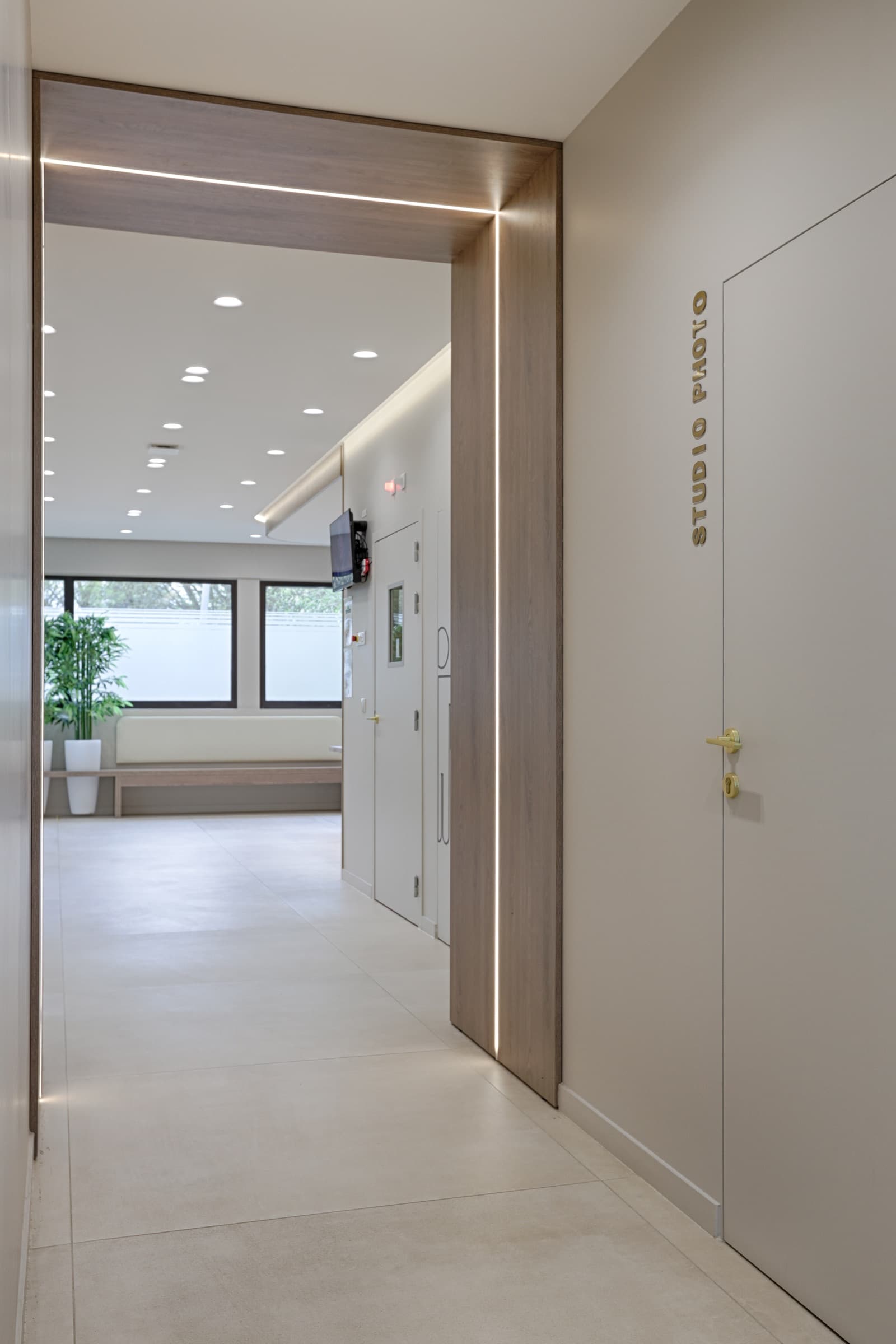 Couloir architectural avec porte Studio Photo en lettres laiton et bandeau LED