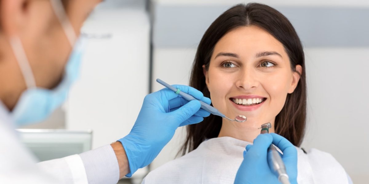 smiling-woman-looking-at-dentist-with-trust-2022-12-16-07-19-25-utc-min.jpg